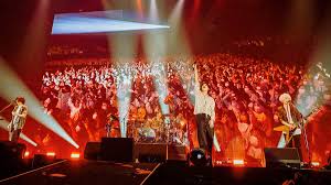 a group of people standing on stage with a stage and a stage